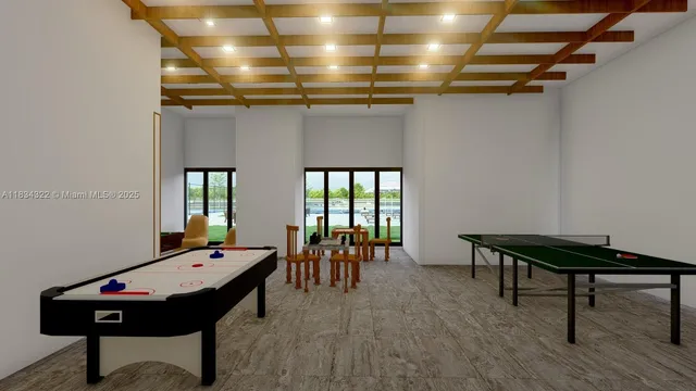 a room with furniture pool table and windows