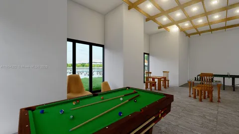 a room with pool table and windows