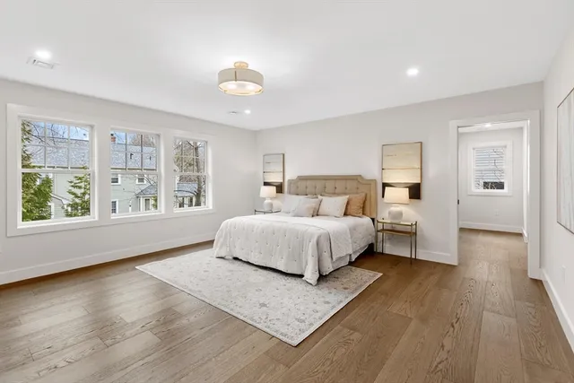 a spacious bedroom with a large bed and a large window