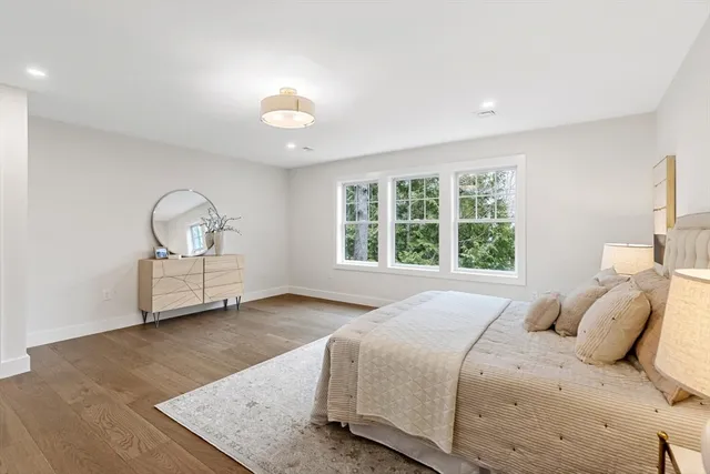 a bedroom with a bed next to a window with outer view and couch