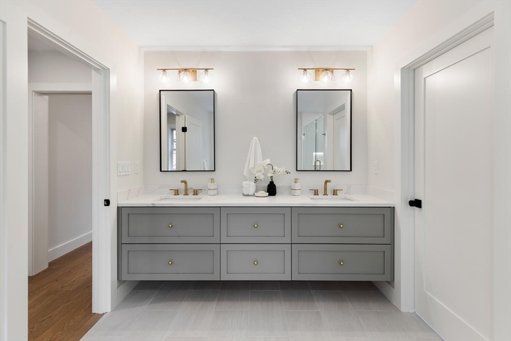 16 Estabrook Road Lexington, MA 02421 - Photo 25 of 38 a bathroom with double vanity sinks and a mirror
