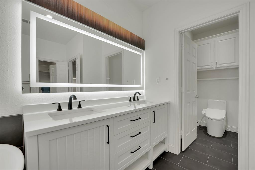 1690 Lynn Lane Lucas, TX 75002 - Photo 20 of 40 a bathroom with a toilet a sink and mirror