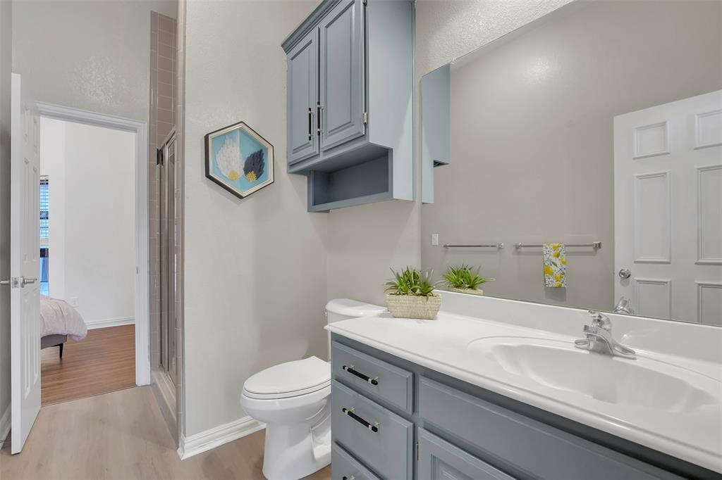 1690 Lynn Lane Lucas, TX 75002 - Photo 24 of 40 a bathroom with a granite countertop toilet sink and mirror