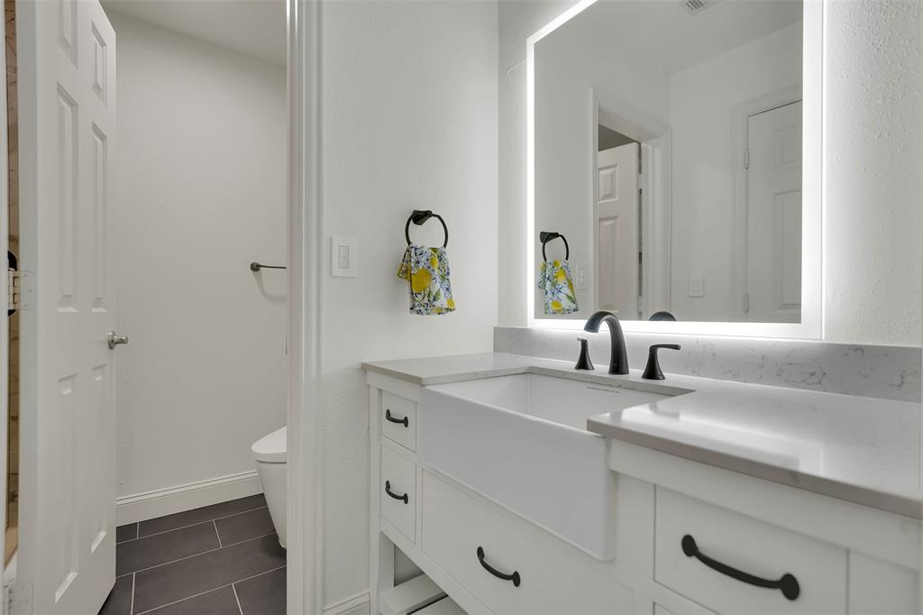 1690 Lynn Lane Lucas, TX 75002 - Photo 27 of 40 a bathroom with a granite countertop sink and a toilet