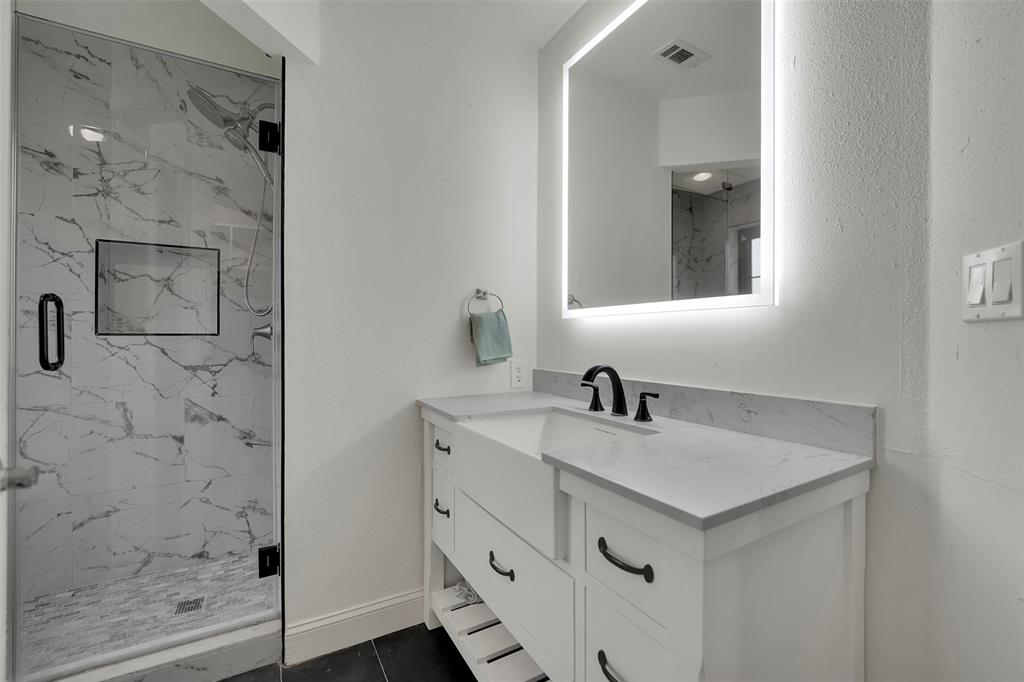 1690 Lynn Lane Lucas, TX 75002 - Photo 28 of 40 a bathroom with a sink vanity and shower