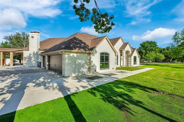 a front view of a house with yard and green space