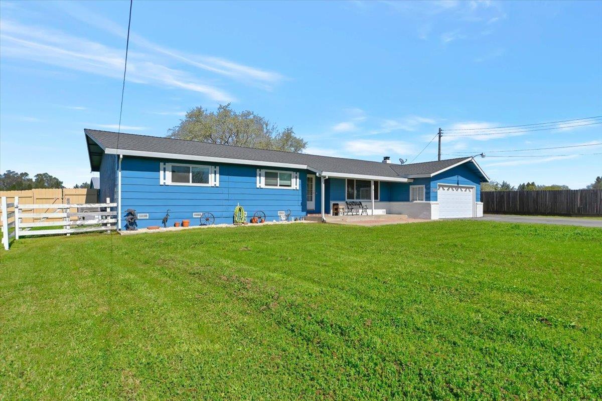 a front view of house with yard and green space