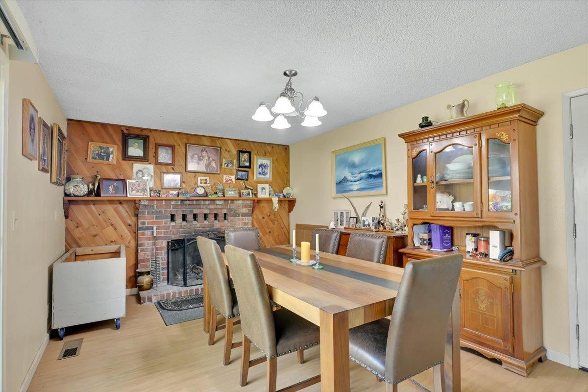 1741 U Street Elverta, CA 95626 - Photo 25 of 33 a view of a dining room with furniture a chandelier and wooden floor
