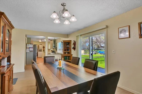 a view of a dining room with furniture wooden floor and a large window