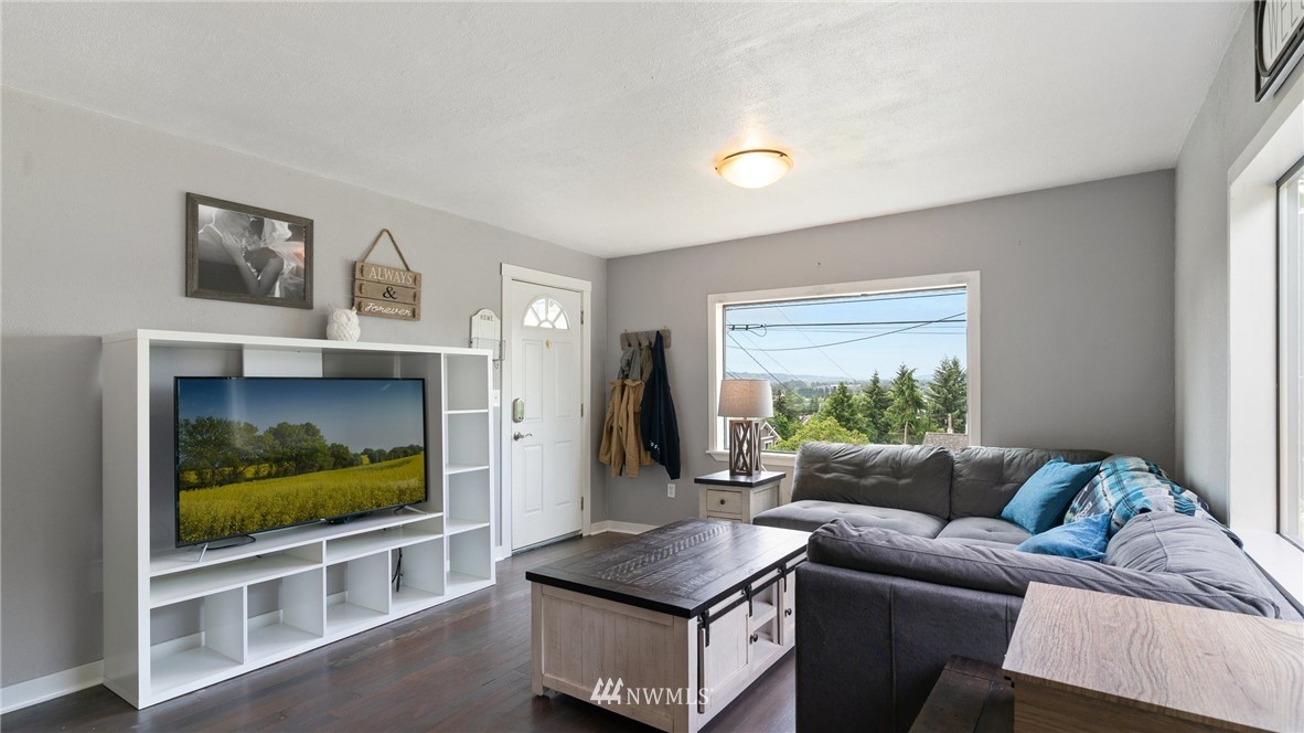 508 Southwest 3rd Place Renton, WA 98057 - Photo 2 of 23 a living room with furniture and a flat screen tv