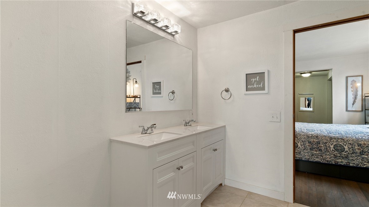 508 Southwest 3rd Place Renton, WA 98057 - Photo 12 of 23 a en suite bathroom with a granite countertop sink and a mirror