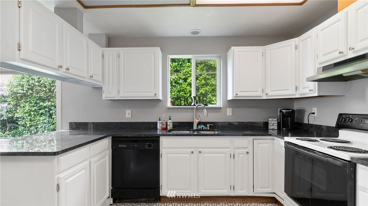 508 Southwest 3rd Place Renton, WA 98057 - Photo 8 of 23 a kitchen with granite countertop white cabinets white appliances and a sink