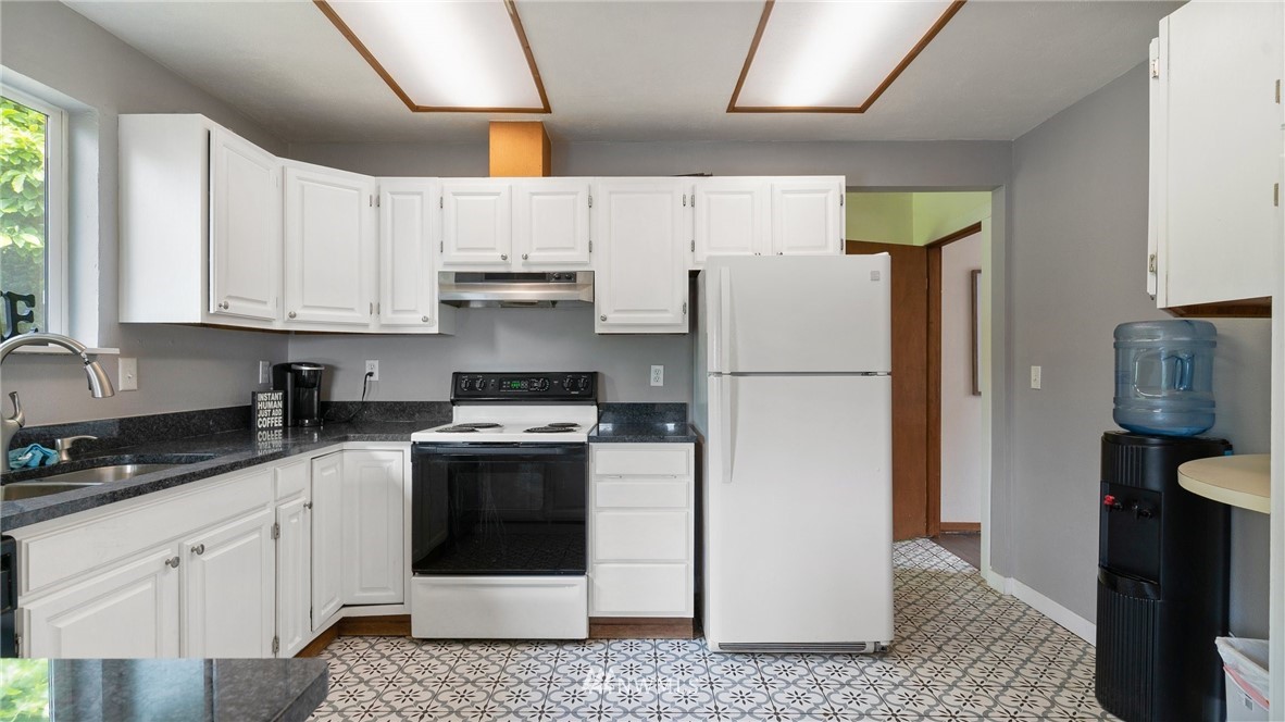 508 Southwest 3rd Place Renton, WA 98057 - Photo 9 of 23 a white refrigerator freezer sitting inside of a kitchen
