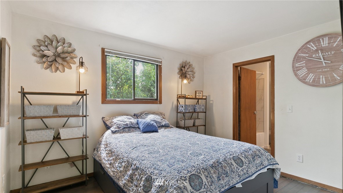 508 Southwest 3rd Place Renton, WA 98057 - Photo 10 of 23 a bedroom with a bed a painting on the wall and a window