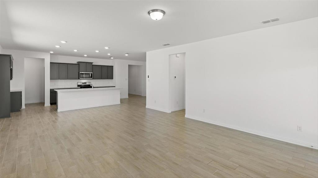 2747 Teton Street Corinth, TX 76210 - Photo 12 of 22 a view of a kitchen with a sink and a refrigerator