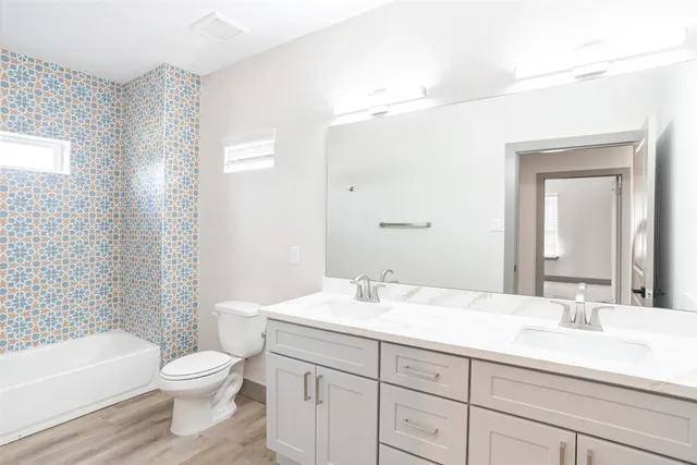 a bathroom with a sink a toilet and a bathtub