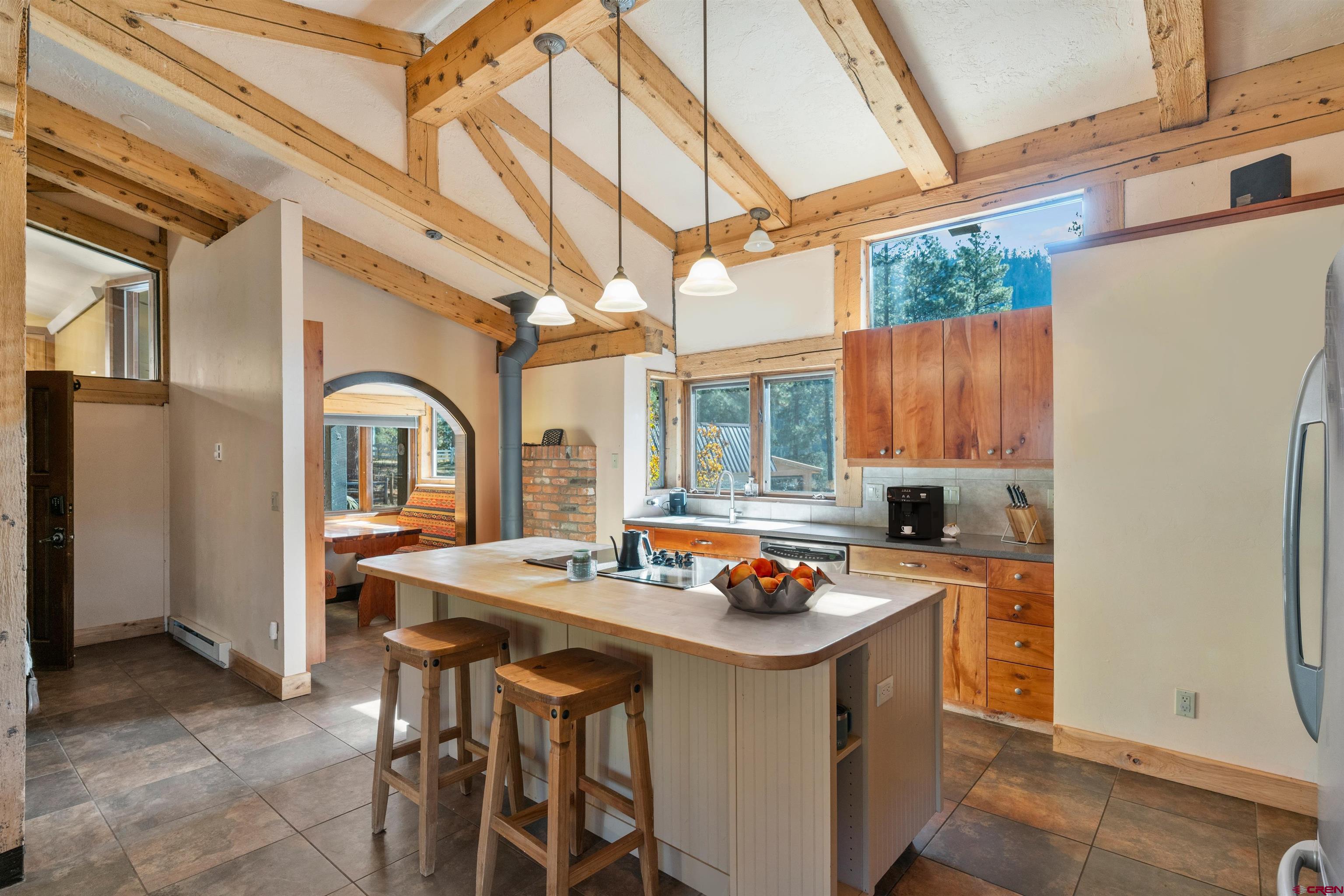 12199 County Road 240 Durango, CO 81301 - Photo 12 of 35 a kitchen with a sink a stove and chairs