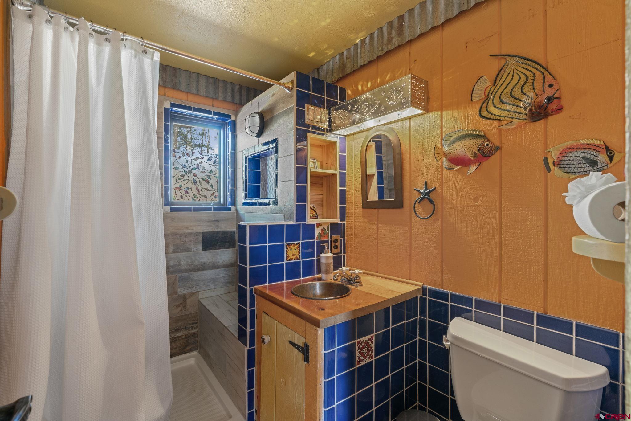 12199 County Road 240 Durango, CO 81301 - Photo 15 of 35 a bathroom with a sink toilet and shower