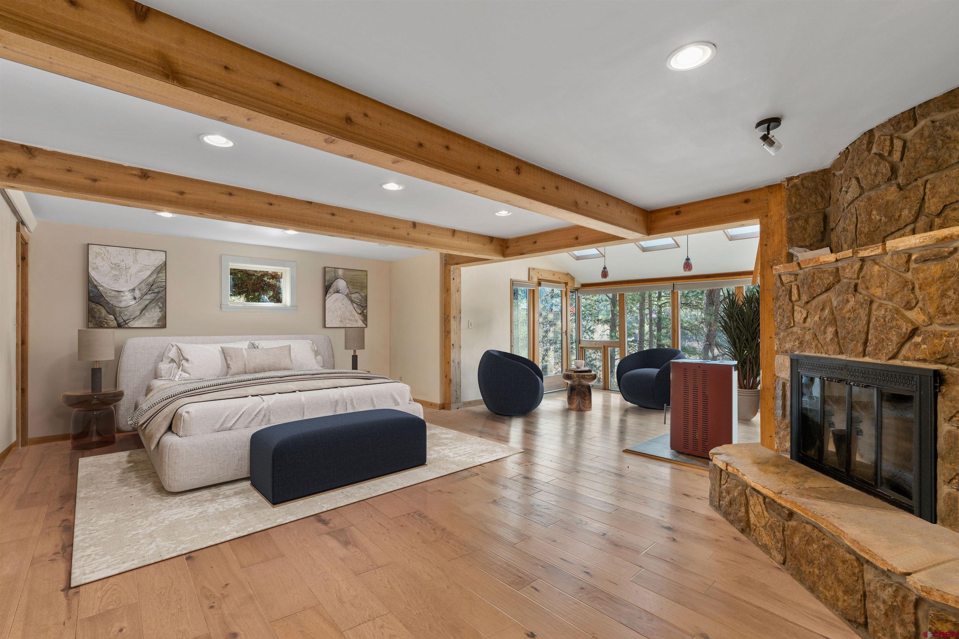 12199 County Road 240 Durango, CO 81301 - Photo 19 of 35 a bedroom with furniture and a fireplace