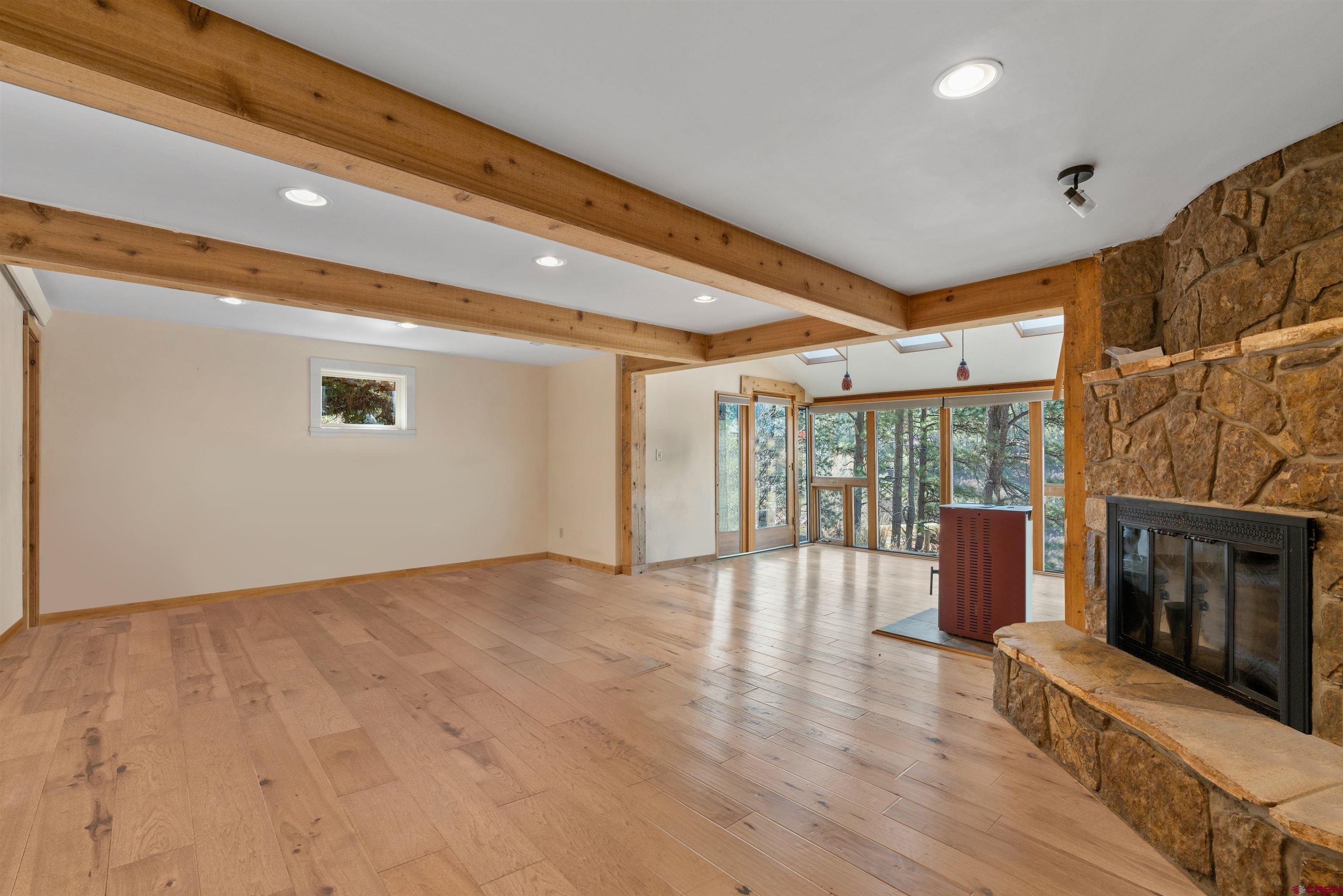 12199 County Road 240 Durango, CO 81301 - Photo 20 of 35 a view of an empty room with wooden floor and a window