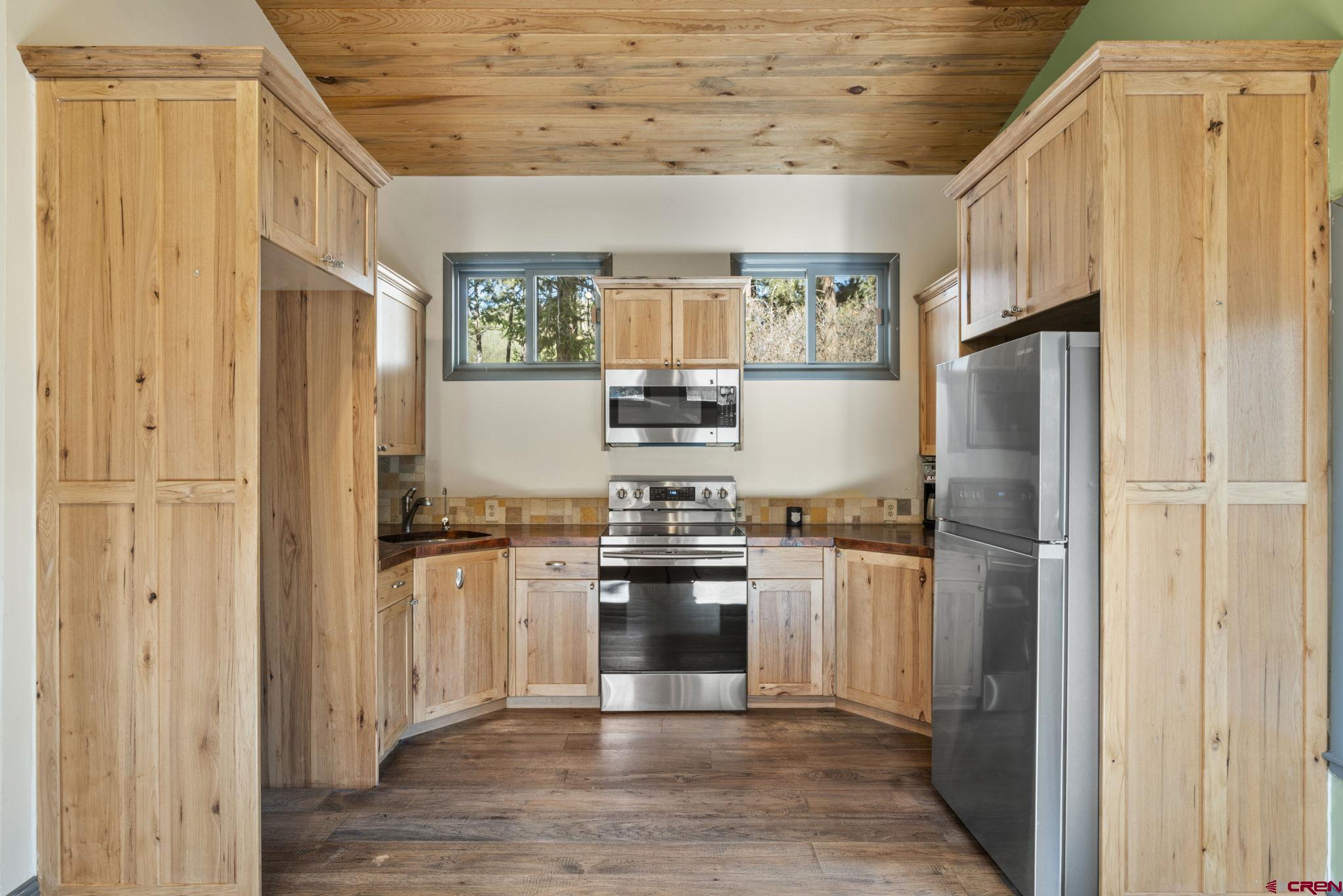 12199 County Road 240 Durango, CO 81301 - Photo 27 of 35 a kitchen with stainless steel appliances granite countertop a refrigerator stove and sink