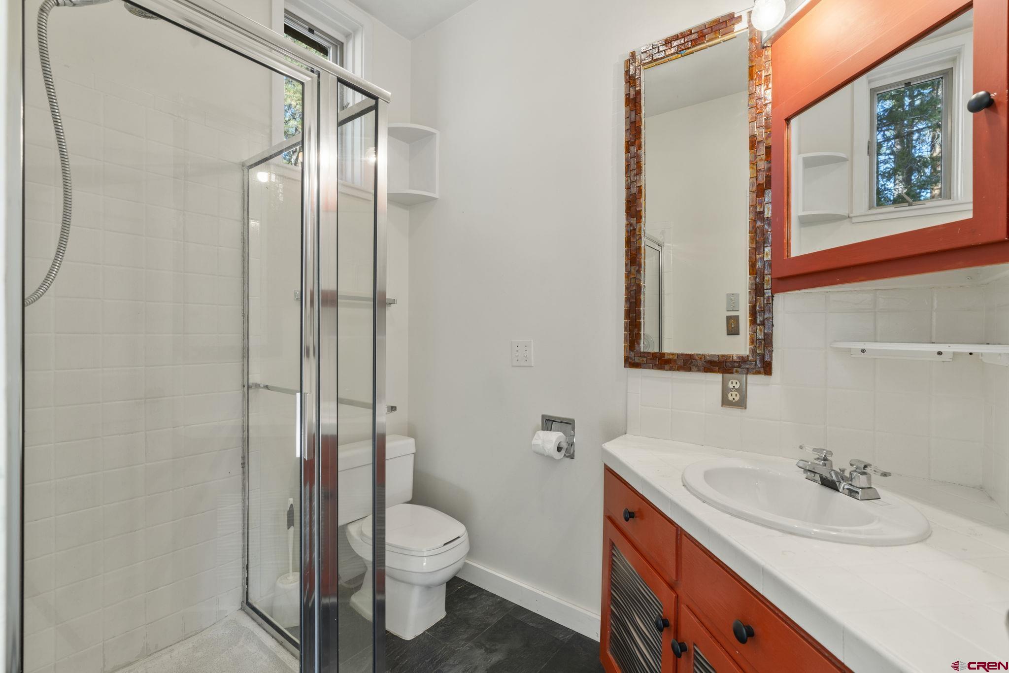 12199 County Road 240 Durango, CO 81301 - Photo 31 of 35 a bathroom with a granite countertop sink toilet and shower