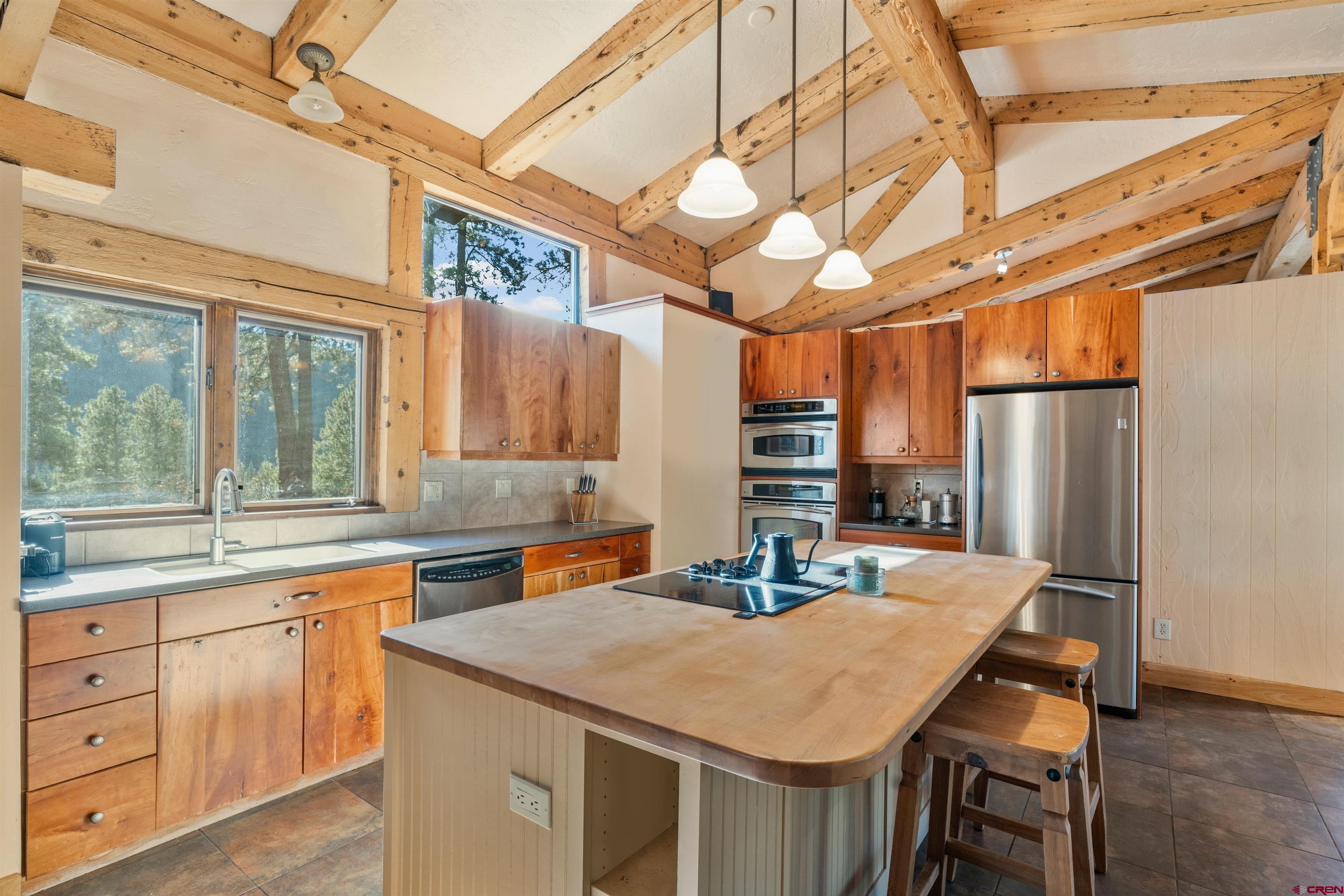 12199 County Road 240 Durango, CO 81301 - Photo 8 of 35 a kitchen with a table chairs and refrigerator