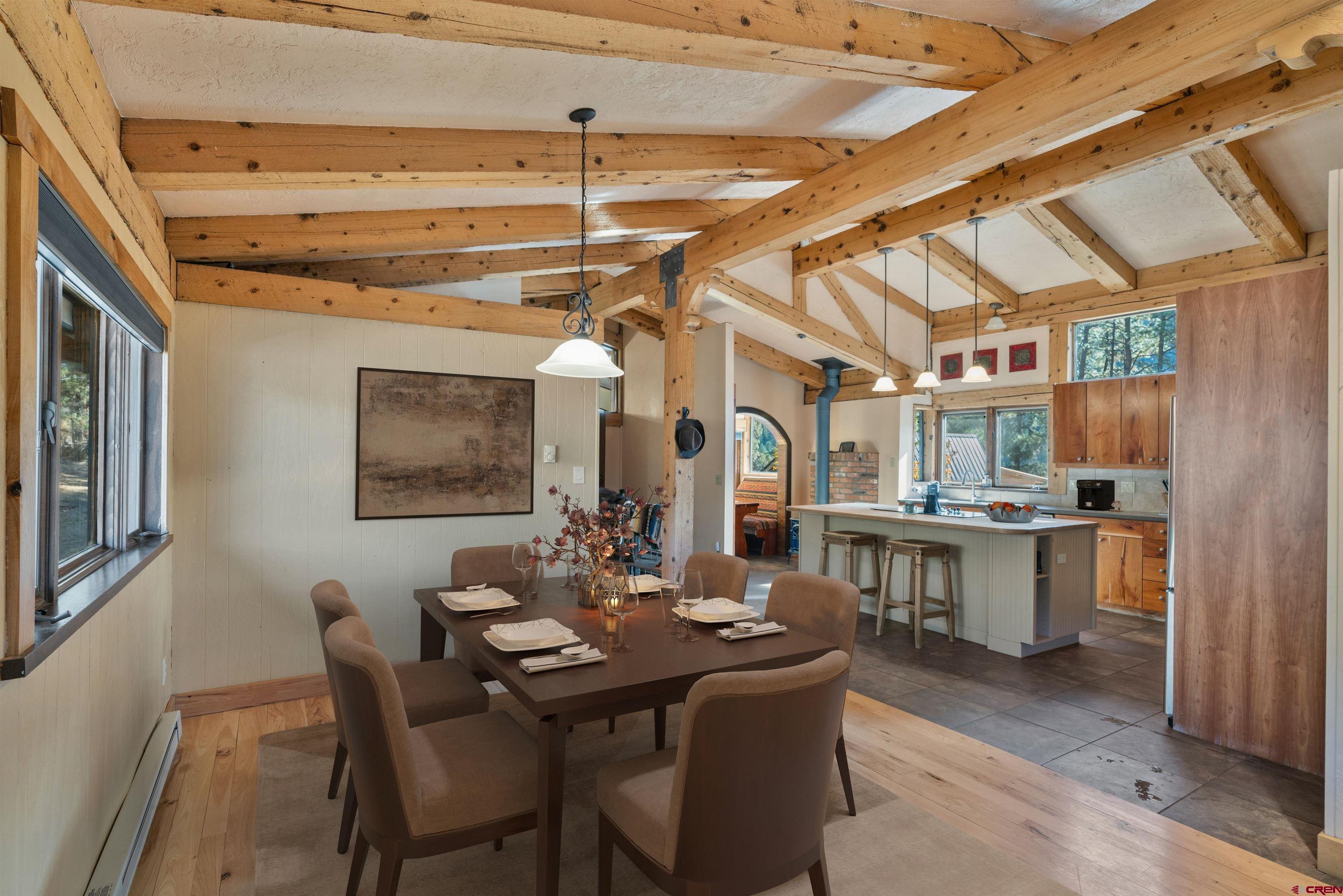 12199 County Road 240 Durango, CO 81301 - Photo 9 of 35 a dining room with a wooden table and chairs