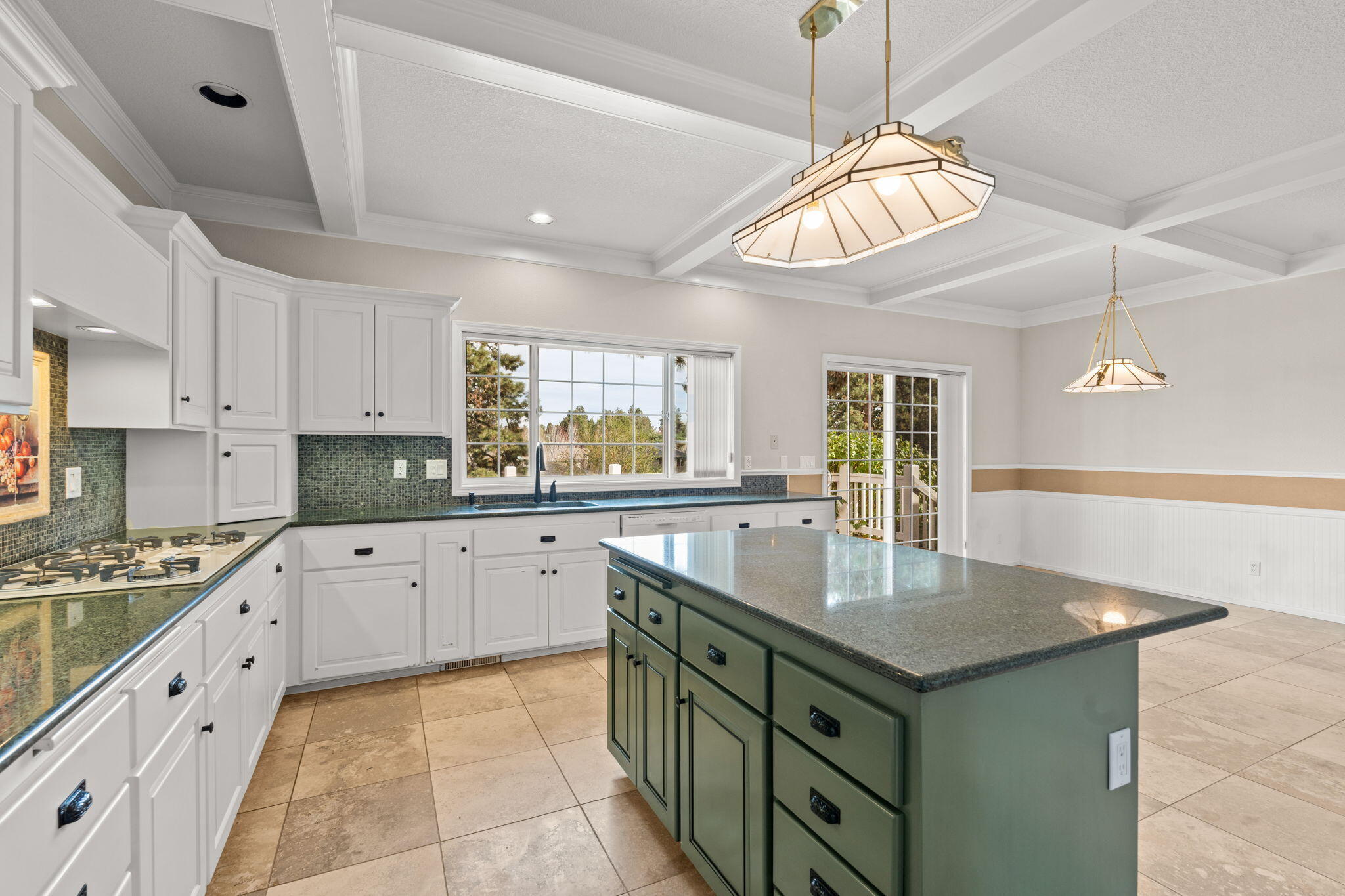 61504 Southeast Hill Ridge Road Bend, OR 97702 - Photo 20 of 70 a kitchen with kitchen island granite countertop a stove and a sink