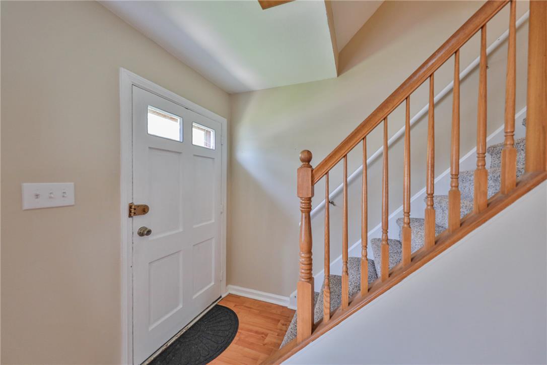 3050 Cornwall Road Bethlehem, PA 18017 - Photo 14 of 80 A welcoming entry features gleaming hardwood flooring and a classic wooden staircase leading to upper levels.