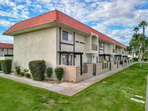 a front view of a house with yard and green space