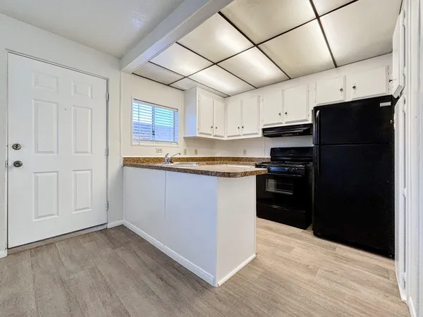 a kitchen with stainless steel appliances granite countertop a refrigerator and a stove top oven