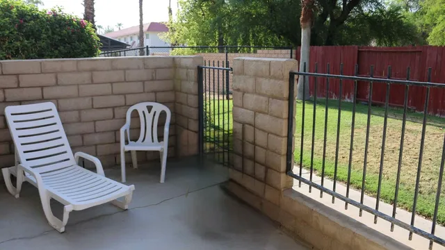 a wooden bench sitting in front of a building