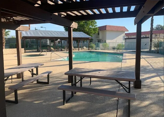 a view of a porch with furniture and a yard