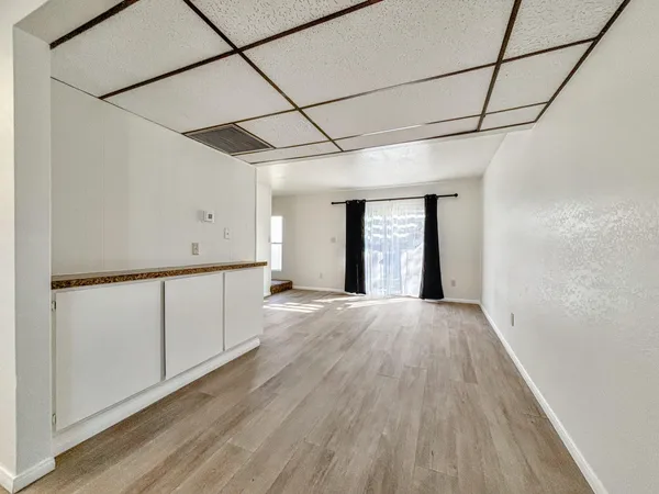 a view of a room with wooden floor and natural light