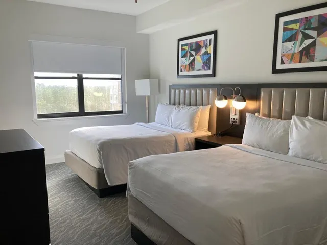 a bedroom with two beds and a window