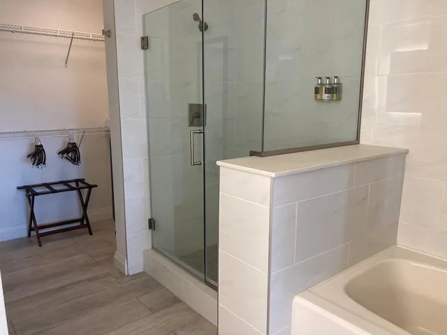 a bathroom with a tub sink and vanity