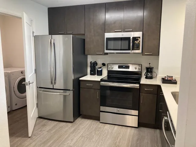 a kitchen with a refrigerator stove and microwave