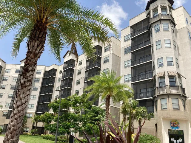 a front view of a multi story building with yard