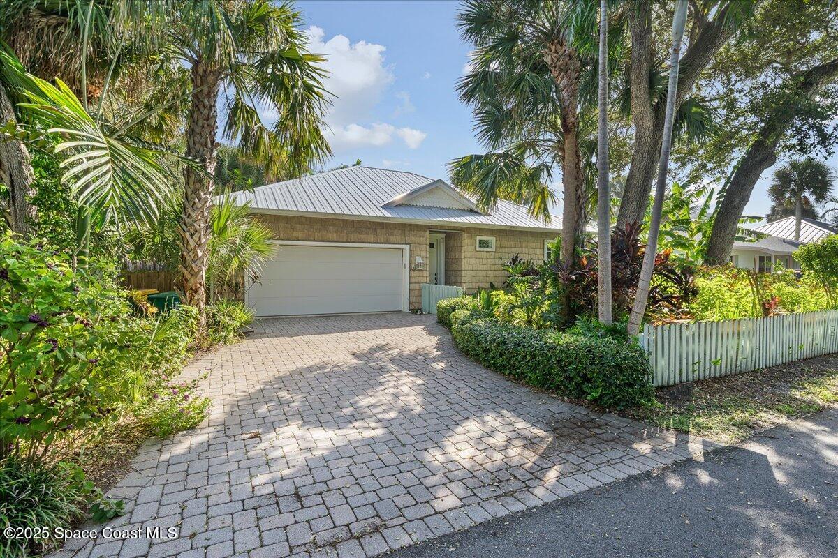 a front view of a house with a garden