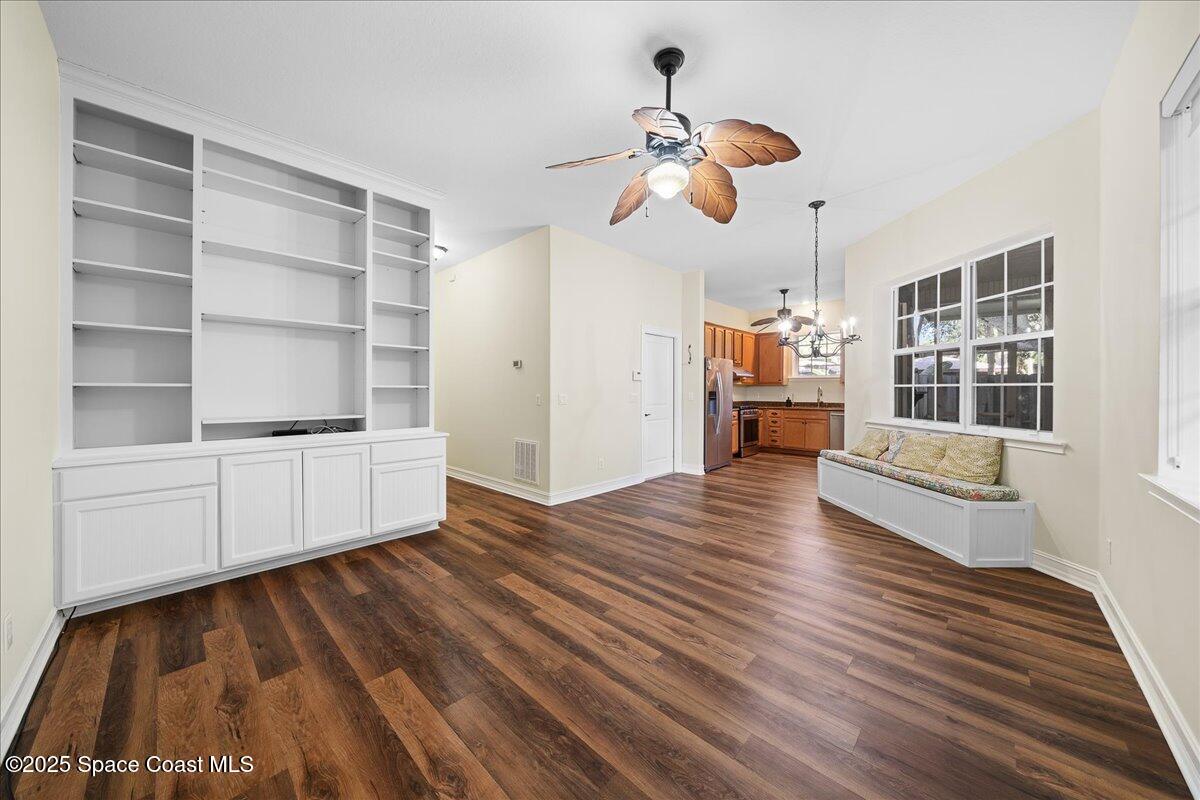 7831 Winona Road Melbourne Beach, FL 32951 - Photo 13 of 41 a view of empty room with a window and wooden floor