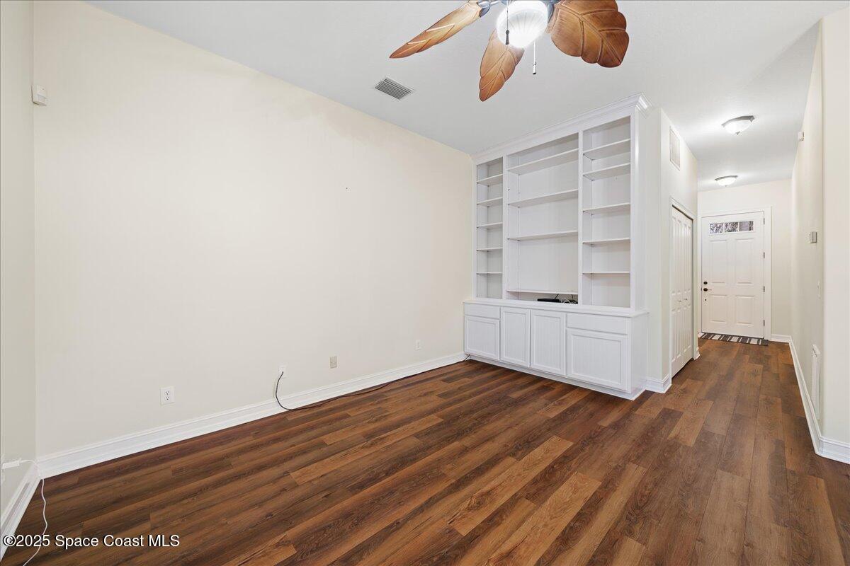7831 Winona Road Melbourne Beach, FL 32951 - Photo 14 of 41 wooden floor in an empty room