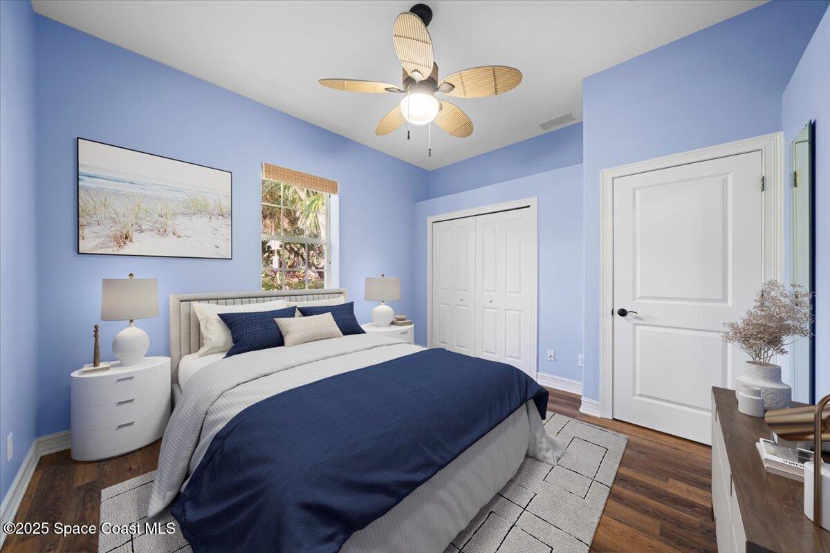 7831 Winona Road Melbourne Beach, FL 32951 - Photo 17 of 41 a bedroom with a bed and a chandelier