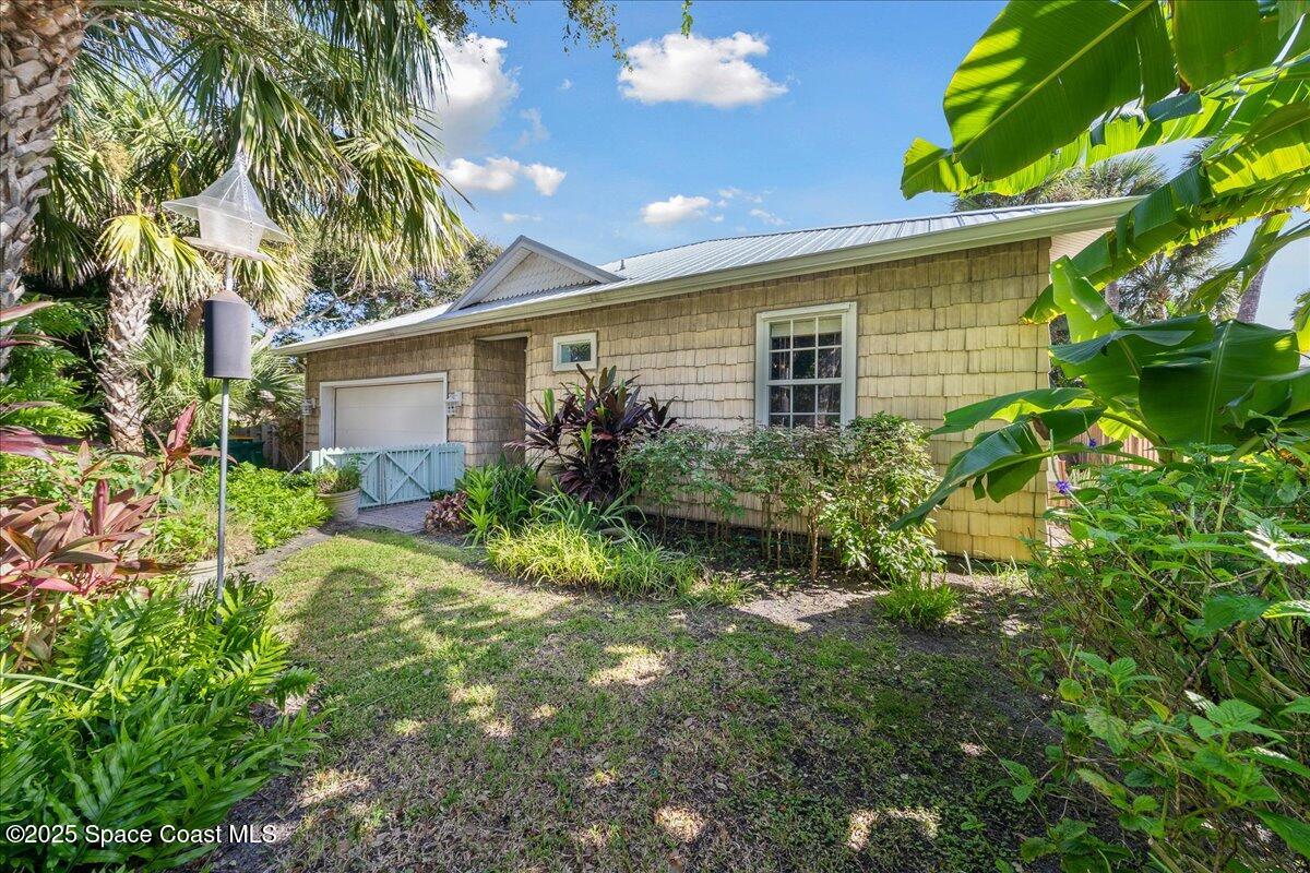 7831 Winona Road Melbourne Beach, FL 32951 - Photo 21 of 41 a view of a house with a yard