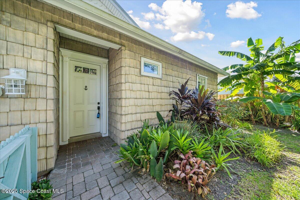 7831 Winona Road Melbourne Beach, FL 32951 - Photo 22 of 41 a couple of potted plants in front of door