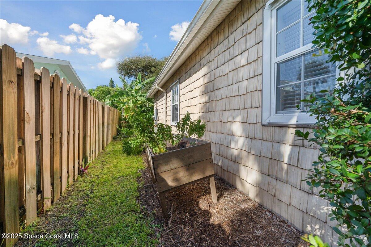 7831 Winona Road Melbourne Beach, FL 32951 - Photo 26 of 41 a wooden bench sitting in front of a building