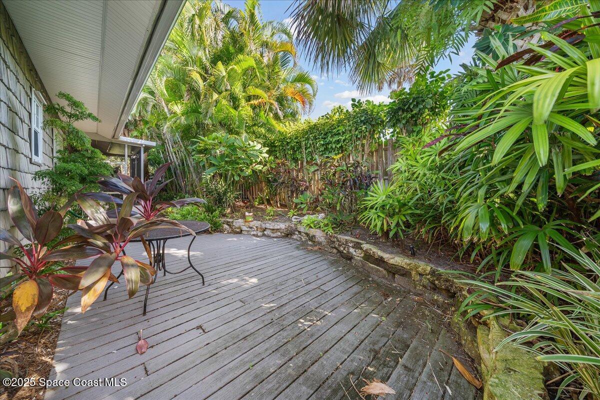 7831 Winona Road Melbourne Beach, FL 32951 - Photo 27 of 41 a bench is sitting in the middle of a backyard