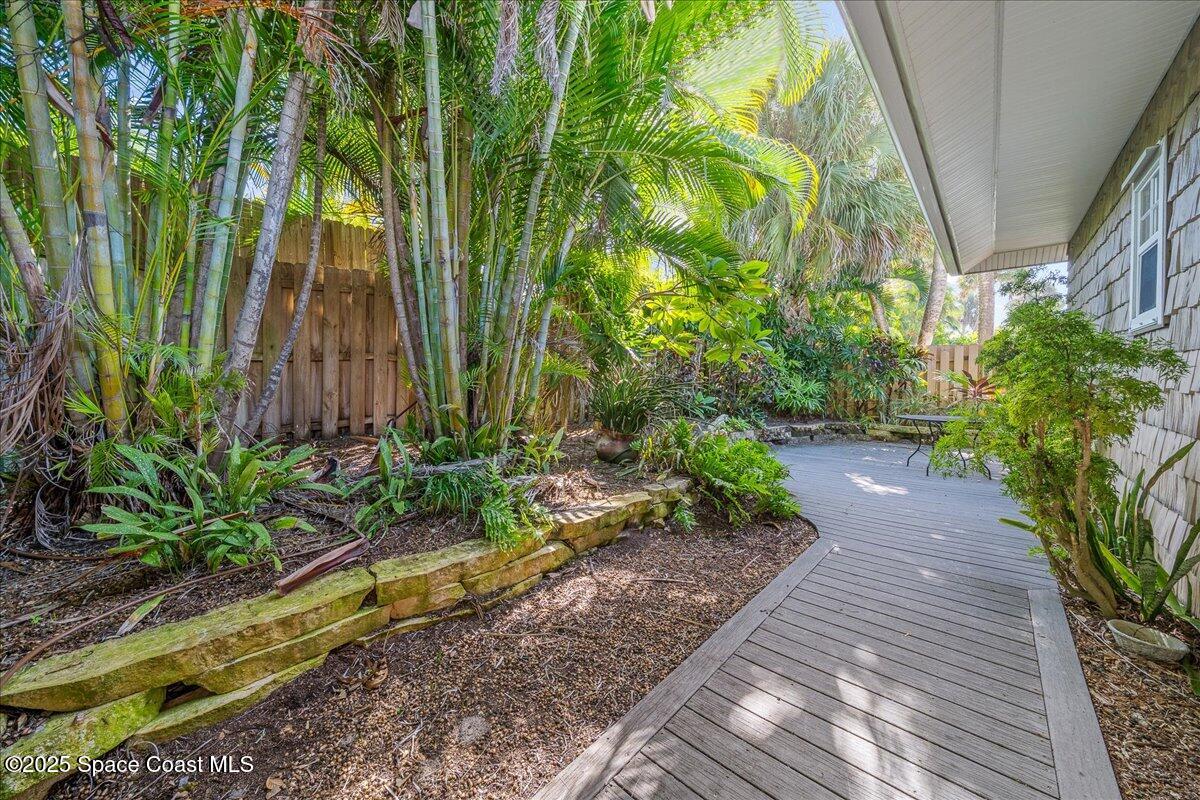 7831 Winona Road Melbourne Beach, FL 32951 - Photo 29 of 41 a view of a backyard with plants and large trees