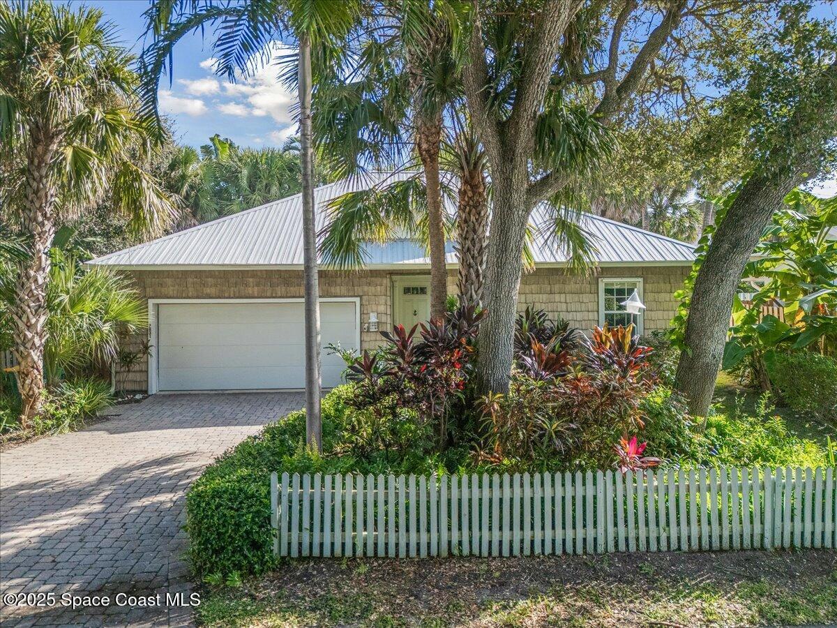 7831 Winona Road Melbourne Beach, FL 32951 - Photo 37 of 41 a front view of a house with a garden