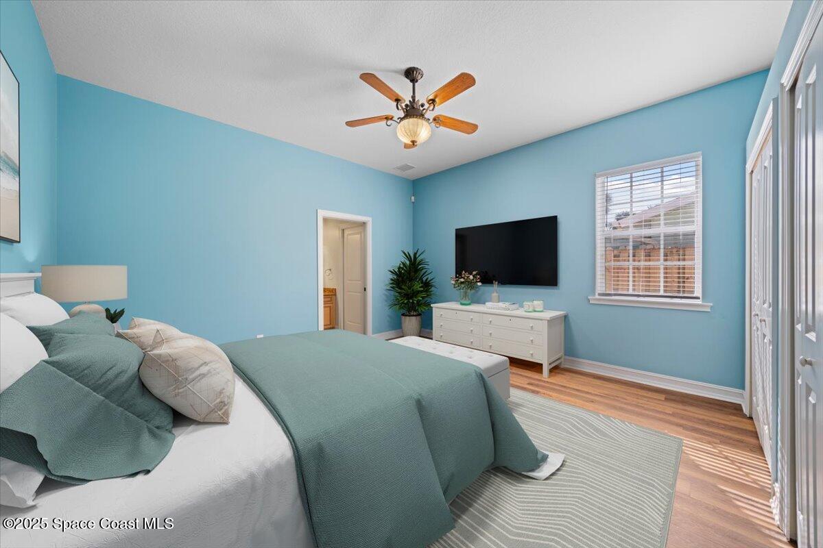 7831 Winona Road Melbourne Beach, FL 32951 - Photo 4 of 41 a bedroom with a bed and a flat screen tv